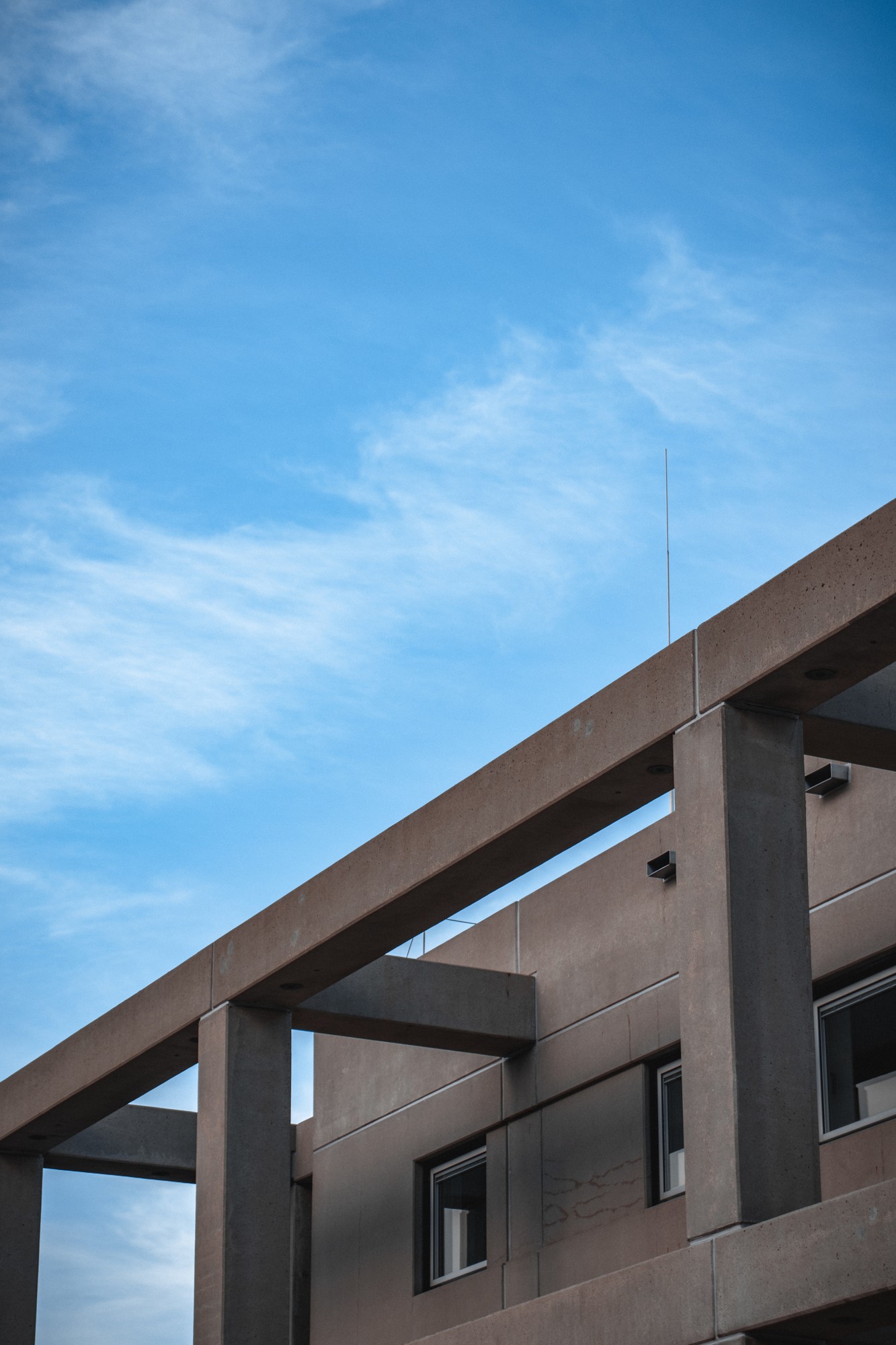 gray-concrete-building-with-pillars